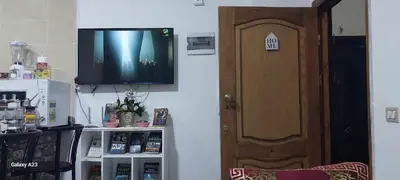 a television hanging on a wall next to a door at Sea Breeze in Hurghada
