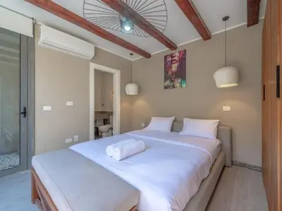 a bedroom with two beds with white sheets at Elegant 2BR Apartment Heated Pool El Gouna in Hurghada