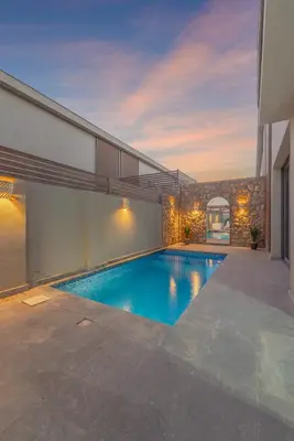 a swimming pool in the backyard of a house at Elegant 2BR Apartment Heated Pool El Gouna in Hurghada