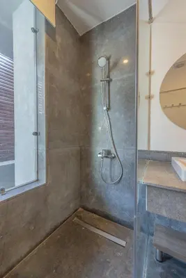 a bathroom with a shower with a glass door at Elegant 2BR Apartment Heated Pool El Gouna in Hurghada