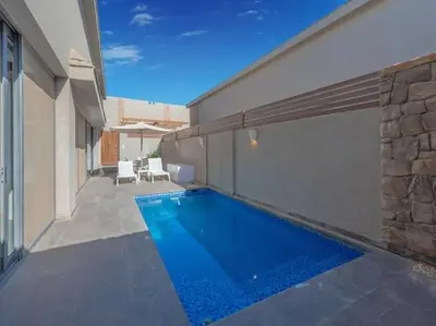a swimming pool in the side of a building at Elegant 2BR Apartment Heated Pool El Gouna in Hurghada