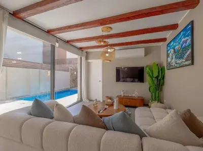 a living room with a large couch and a large window at Elegant 2BR Apartment Heated Pool El Gouna in Hurghada
