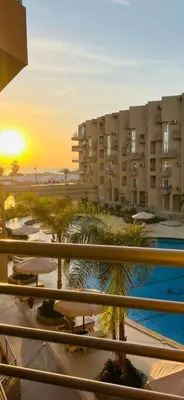 a view from a balcony of a building with a pool at Princess Resort Lovely Studio in Hurghada
