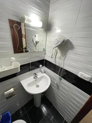 a bathroom with a sink and a mirror at Sherathon studio Pavel in Hurghada