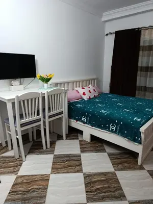 a bedroom with a bed and a desk and a computer at Sherathon studio Sheri in Hurghada