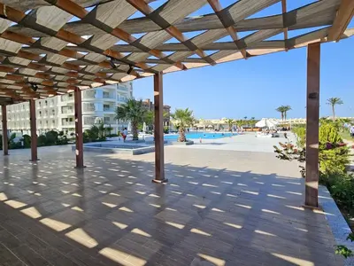 a pavilion at the beach with a building in the background at Scandic Resort Hurghada App-C310 in Hurghada