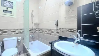 a bathroom with a sink and a toilet and a tub at La Quinta Beach Resort in Hurghada in Hurghada