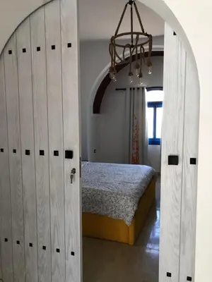 a bedroom with a bed and an open door at Chalet with private pool in Hurghada