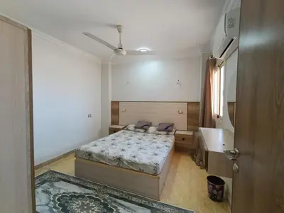 a bedroom with a bed and a sink in it at 3 Bedroom in Lotus in Naj‘ al Maḩaţţah