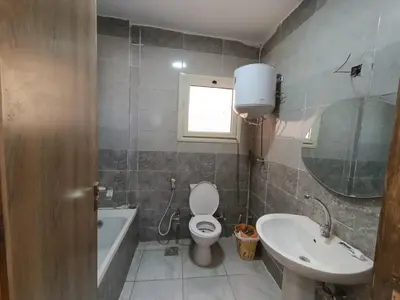 a bathroom with a toilet and a sink and a tub at 3 Bedroom in Lotus in Naj‘ al Maḩaţţah