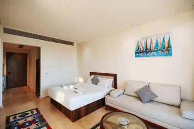 a hotel room with a bed and a couch at Tranquil Terrace Studio at Ancient Sands in Hurghada