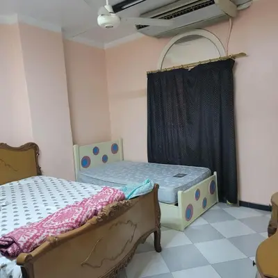 a bedroom with two beds and a window at OS & MA Luxor APT in Luxor