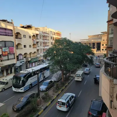 a busy city street with cars and a bus at OS & MA Luxor APT in Luxor