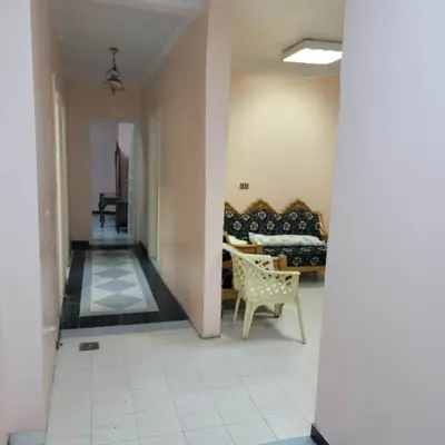 a living room with a couch and a chair at OS & MA Luxor APT in Luxor