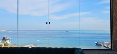 a large window with a view of the ocean at Sea view Penthouse sea front city center 11 in Hurghada