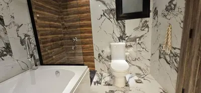 a bathroom with a tub and a toilet and a sink at Sea view Penthouse sea front city center 11 in Hurghada