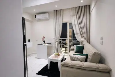 a living room with a couch and a table at Luxury Sea View Apt near Beach - 2 Pools - Balcony in Hurghada