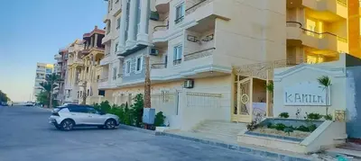 a white car parked in front of a building at Gamal in Hurghada