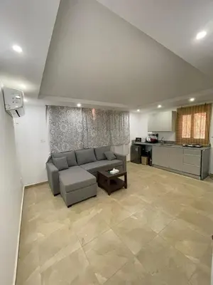 a large living room with a couch and a kitchen at Sea-Front Selena Bay Resort Apartment in Hurghada