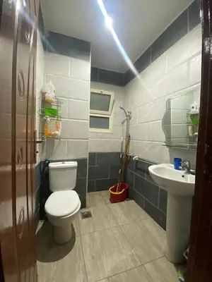 a bathroom with a toilet and a sink at 2-Room Apartment with Swimming Pool in Hurghada