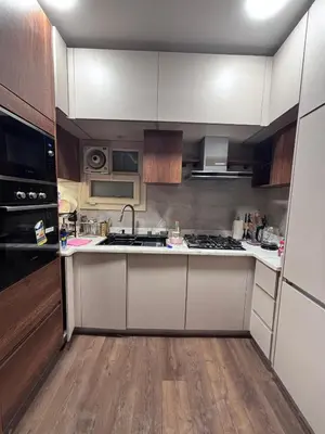 a kitchen with white cabinets and a stove top oven at Unique apartment in hurghada in Hurghada