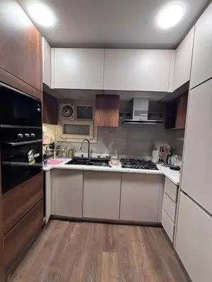 a kitchen with white cabinets and a stove top oven at Unique apartment in hurghada in Hurghada