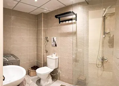 a bathroom with a toilet and a shower and a sink at Arabia FANTA SEA - Stylish Pool Level Studio in Florenza Hrg in Hurghada