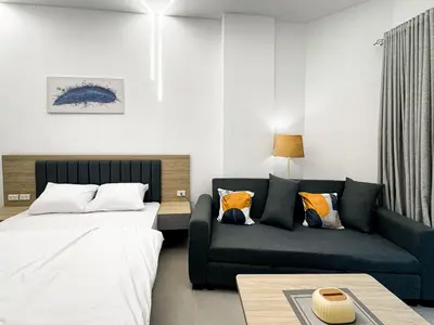 a living room with two beds and a couch at Arabia FANTA SEA - Stylish Pool Level Studio in Florenza Hrg in Hurghada