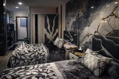 a hotel room with two beds and a wall with at Tiba Golden in Hurghada