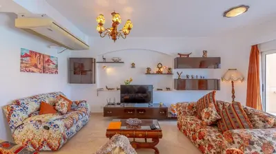 a living room with two couches and a tv at VESTA - El Gouna Residence in Hurghada