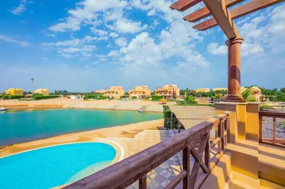 a balcony with a view of a swimming pool at VESTA - El Gouna Residence in Hurghada