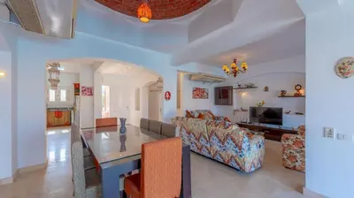 a living room with a table and a couch at VESTA - El Gouna Residence in Hurghada