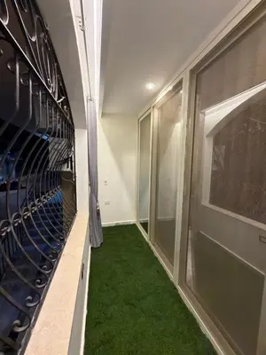 a hallway with a green carpet in a baseball dugout at Hurghada - European standard apartment for rent! in Hurghada