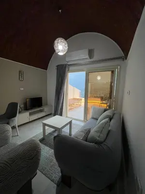 a living room with a couch and a table at Luxury Sea-View Rooftop with Private Terrace in Hurghada