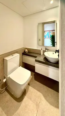 a bathroom with a white toilet and a sink at The Two Sisters - Kamaran, El Gouna in Hurghada