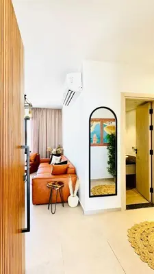 a living room with a couch and a mirror at The Two Sisters - Kamaran, El Gouna in Hurghada