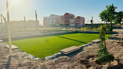 a field of grass in front of a building at The Two Sisters - Kamaran, El Gouna in Hurghada