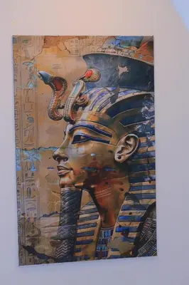 a painting of a face with feathers on a wall at sunrise house in Luxor