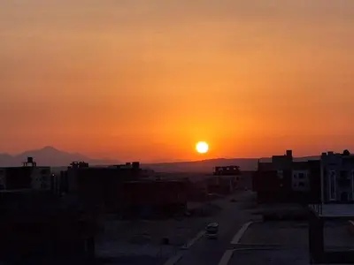 a sunset over a city with a road and buildings at The Arabic Jewel 2 Bedroom Home plus Sun Roof Terrace in Hurghada