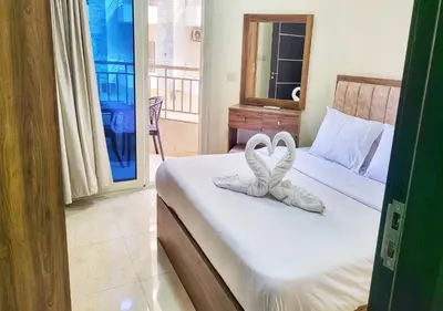 a bedroom with a bed with two towels on it at La Quinta Beach Resort Hurghada in Hurghada