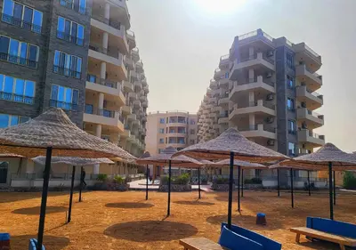 a group of umbrellas in front of a building at La Quinta Beach Resort Hurghada in Hurghada