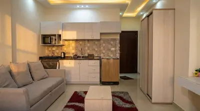 a living room with a couch and a kitchen at Seaside studio with private Beach and pool in Hurghada