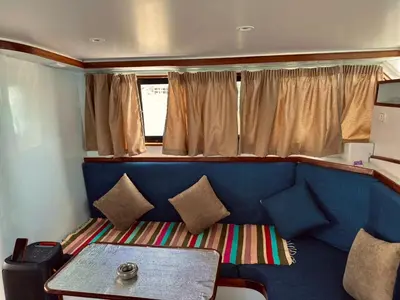 a living room with a blue couch and a table at TaiTours in Hurghada