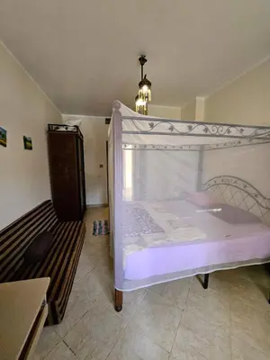 a bed with a canopy in a room at Sea-View apartment in El Andalous in Hurghada