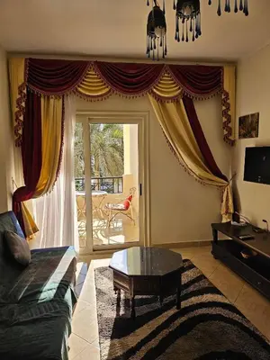 a living room with a couch and a glass table at Sea-View apartment in El Andalous in Hurghada