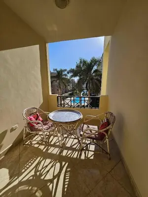 a balcony with a table and two chairs and a window at Sea-View apartment in El Andalous in Hurghada