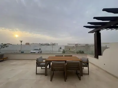 a table and chairs in a room with a view at Ancient Sands 2BR | Ground Floor, Pool Access in Hurghada