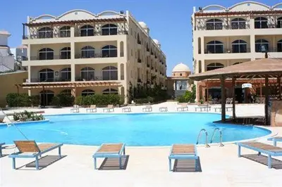 a large swimming pool in front of a building at Palm Beach Piazza Apart hotel Sahl Hasheesh Hurghada in Hurghada