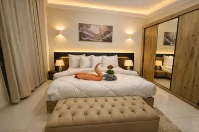 a bedroom with a bed with a stuffed dinosaur on it at Star Luka in Luxor