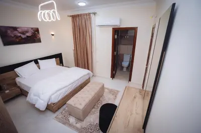 a bedroom with a white bed and a bathroom at Star Luka in Luxor